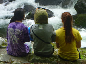 Girls sitting by the creek