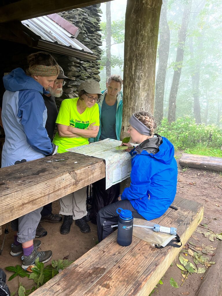 backpacking guide going over the next days route with guests