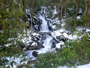 Winter waterfall with snow covered rocks