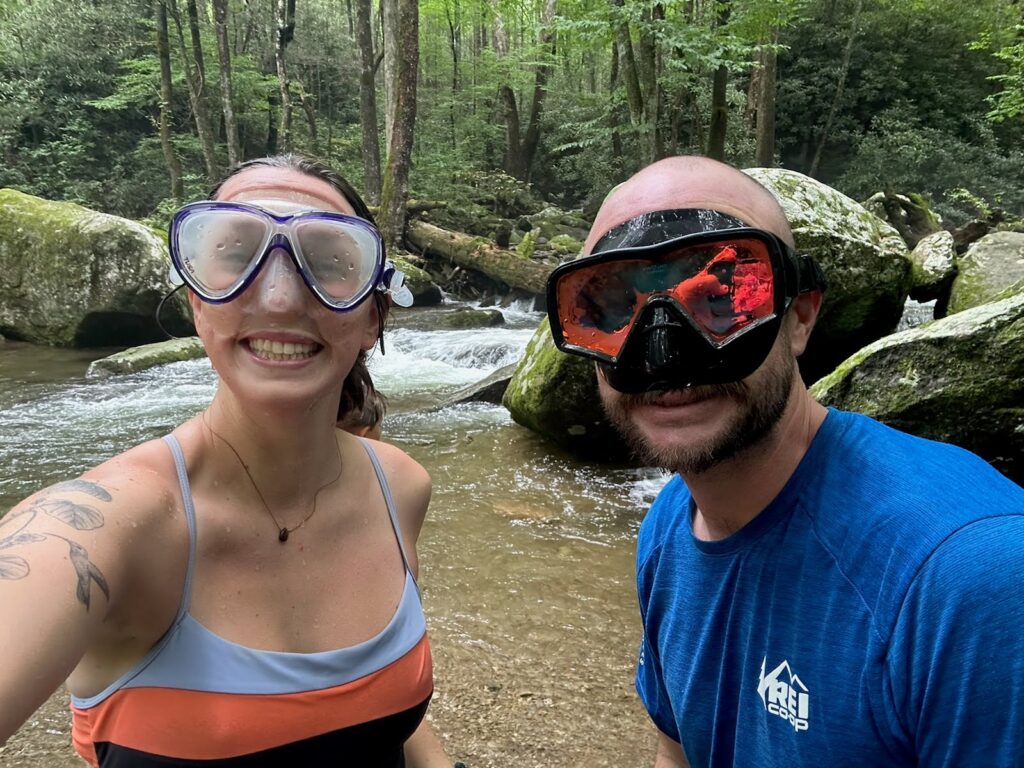 Guides, Ansley and Ben, playing in the river with snorkel masks on for our Adult Summer Camp
