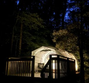 Camp Atagahi tent on platform at night