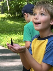 Kid excited to have butterfly land in his hands!