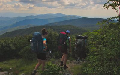 Backpackers on top of the mountain with a gorgeous view.