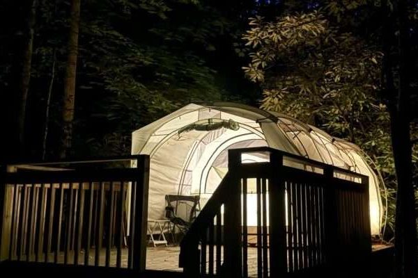 Camp Atagahi tent aglow at night. Illuminated from the inside by camp lanterns.