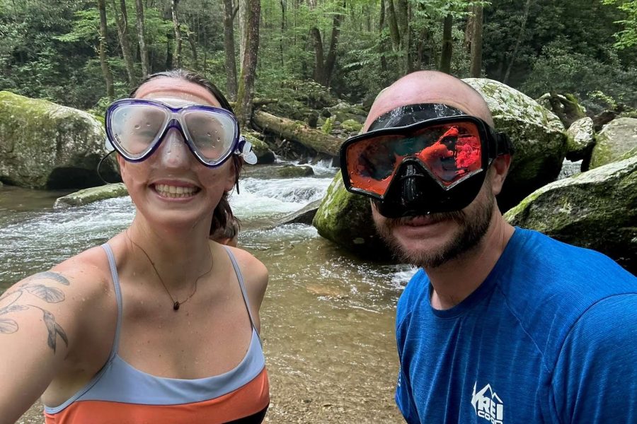 Guides, Ansley and Ben, playing in the river with snorkel masks on for our Adult Summer Camp